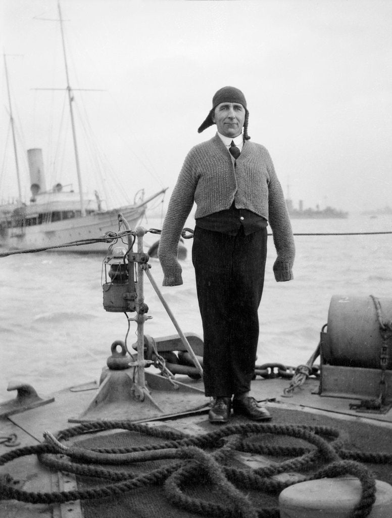 Detail of Gunner William G. Worsh of the destroyer 'Swallow' proudly showing off his latest comforts from home, a hand-knitted cardigan and balaclava by unknown