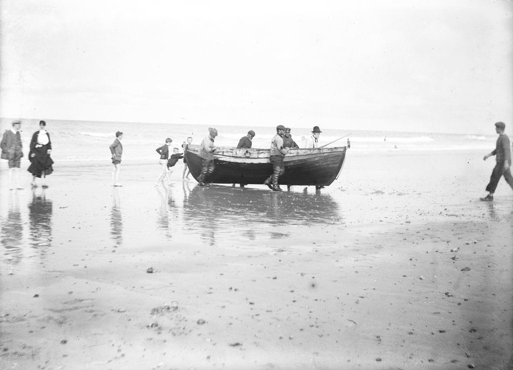Detail of Five fishermen carrying a Sheringham crab boat up the beach, assisted by three boys, at Lowestoft by Smiths Suitall Ltd.