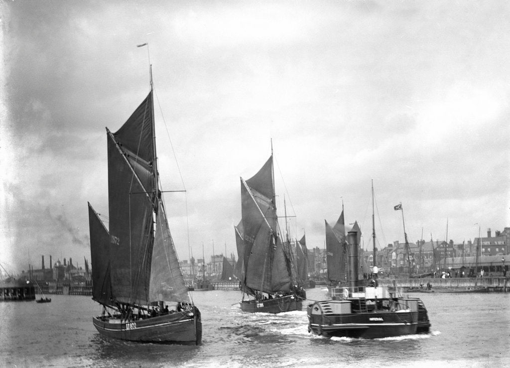 Detail of The trawler 'LT372' under sail with 'LT205' in tow of the paddle tug 'Imperial' (1879) leaving the harbour at Lowestoft, Suffolk by Smiths Suitall Ltd.