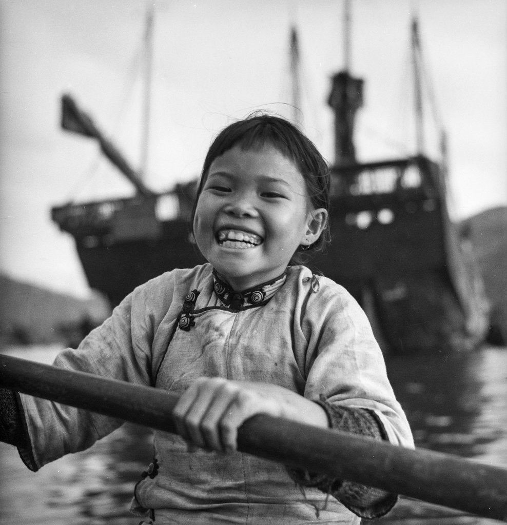 Detail of A portrait of a young girl in a sampan in Aberdeen harbour, Hong Kong. by David Watkin Waters