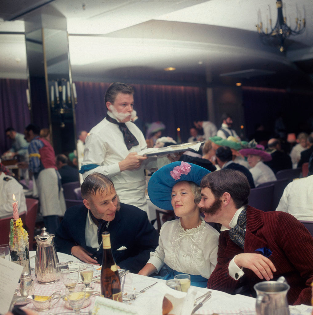 Detail of A Victorian themed dinner aboard an unspecified cruise liner, with period costume and fake 'lamb chops' facial hair aplenty, provides much merriment for passengers by Union Castle Line Collection