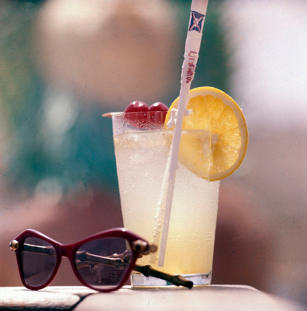 Detail of Cocktail and sunglasses aboard a Union-Castle cruise liner by Marine Photo Service