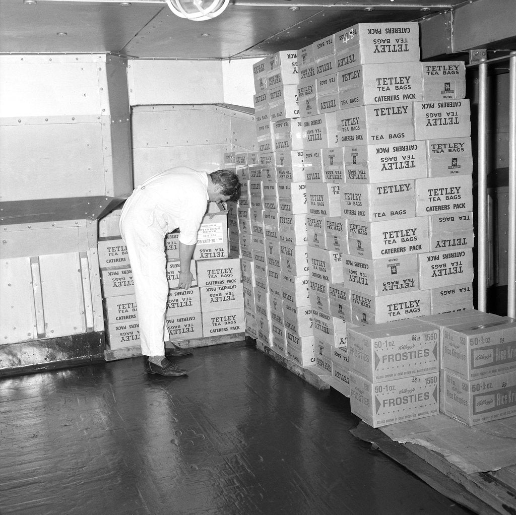 Detail of A storeroom containing boxes of Tetley's tea bags and Kellogg's Frosties, onboard 'Iberia' (1954) by Marine Photo Service