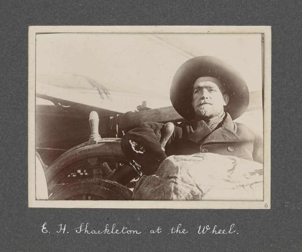 Detail of E. H. Shackleton at the wheel from National Antarctic Expedition photo album by Sir Ernest Henry Shackleton