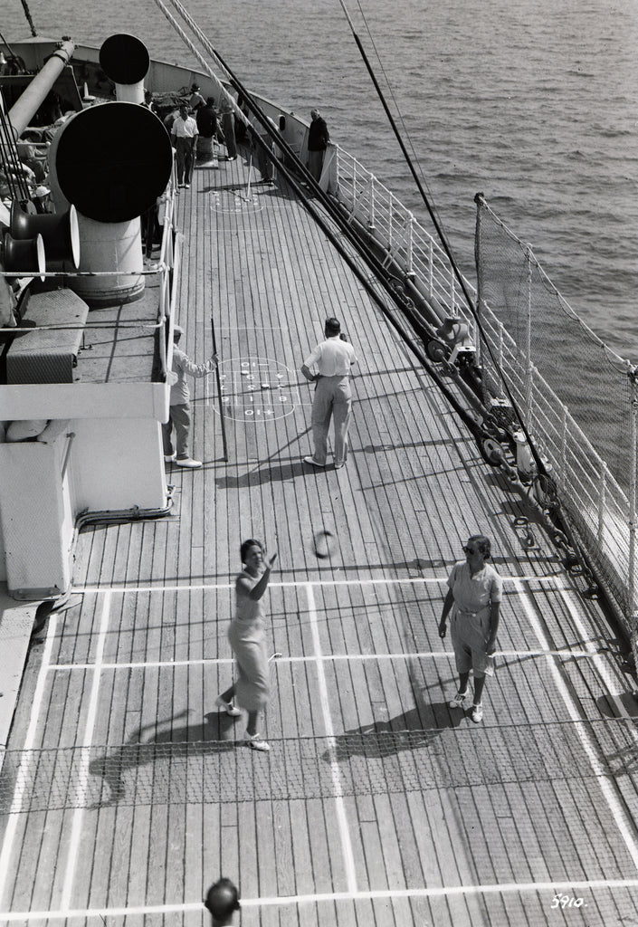 Detail of Passengers playing deck tennis and shuffleboard on the forecastle deck on board an unidentified cruise ship. by Marine Photo Service