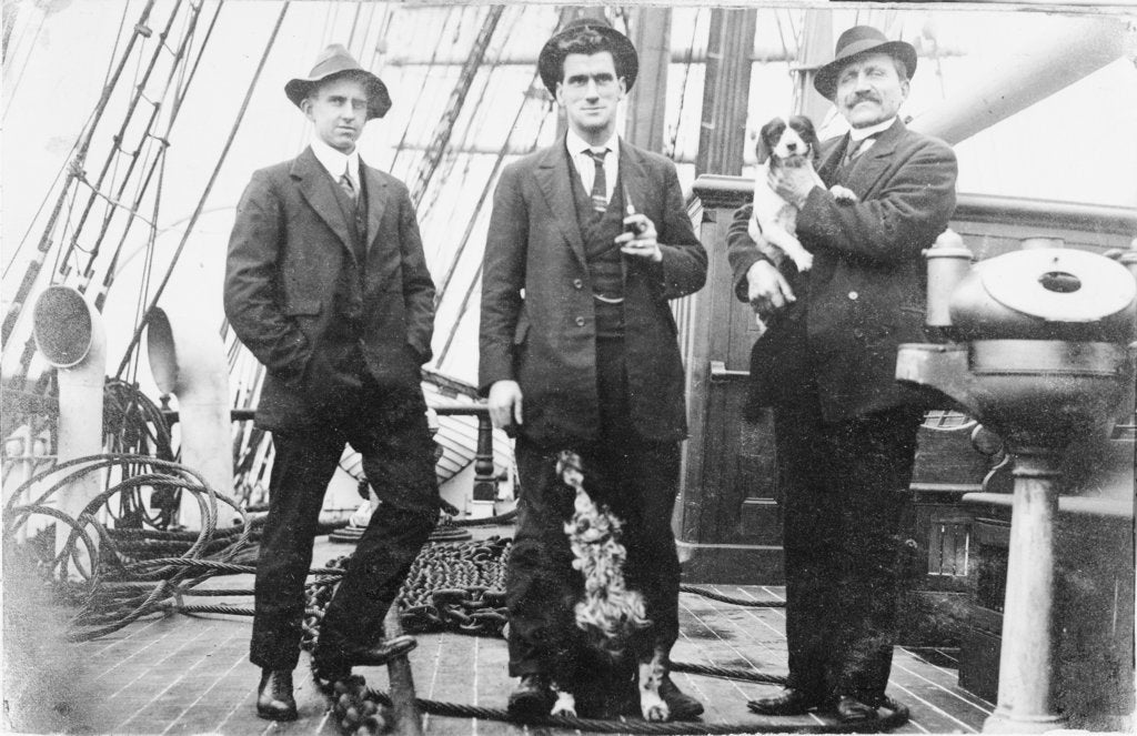 Detail of Second Officer, Captain H.J. Bray (with dog Ollie) and Chief Officer standing on deck, at Tacoma, USA by unknown