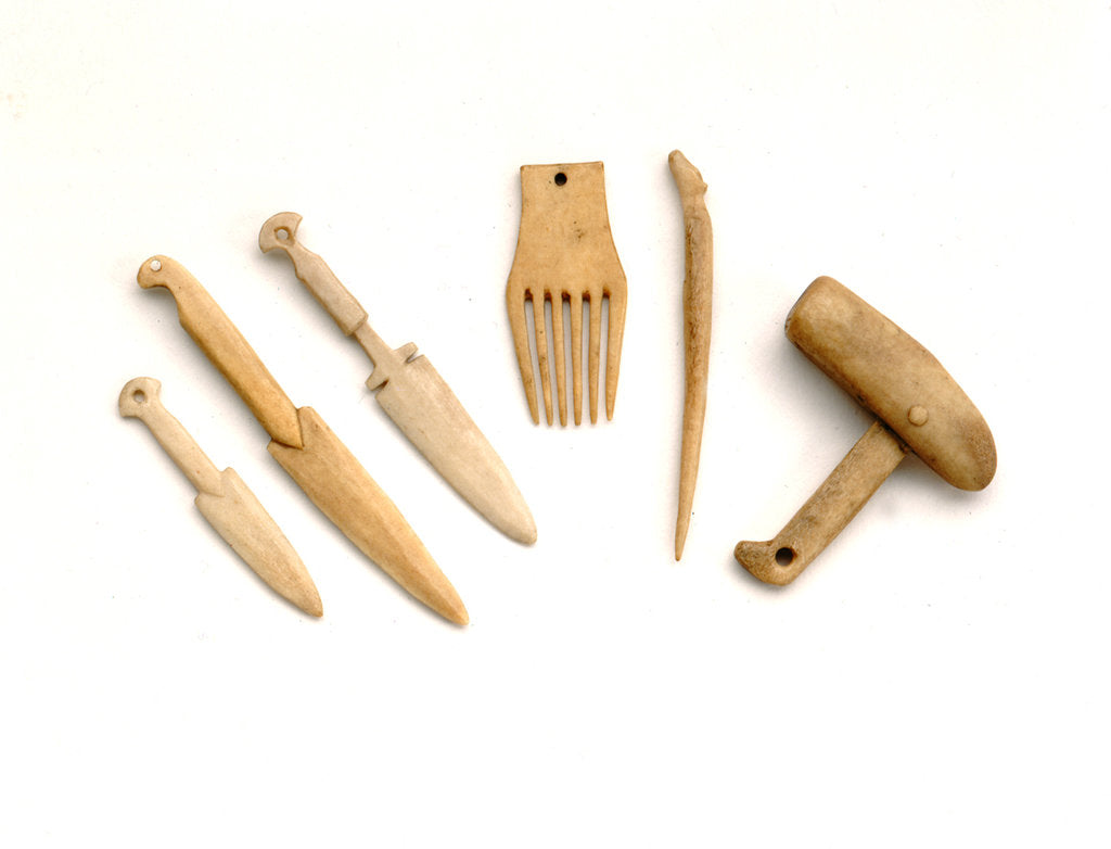 Detail of Ivory model of a snow knife, awl, comb by unknown