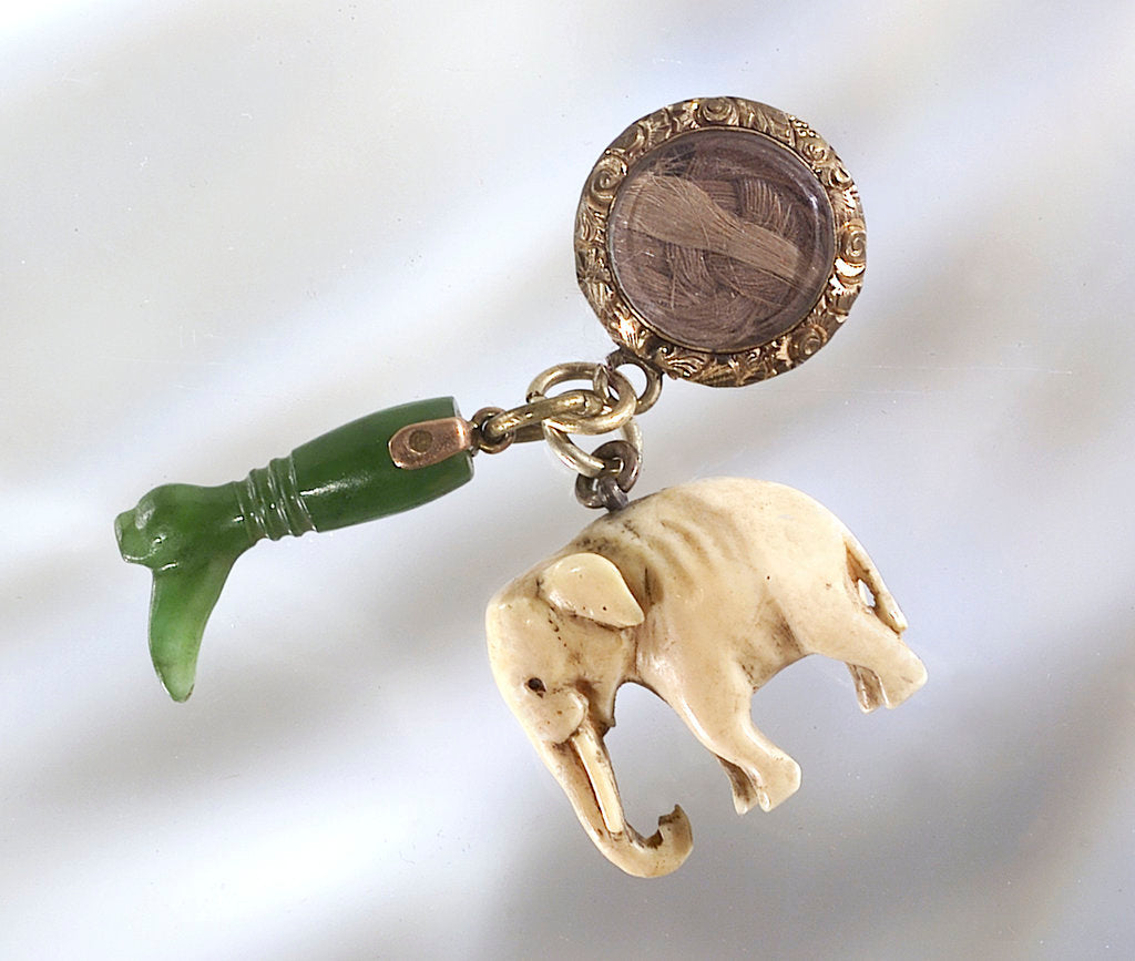 Detail of A collection of three charms by unknown