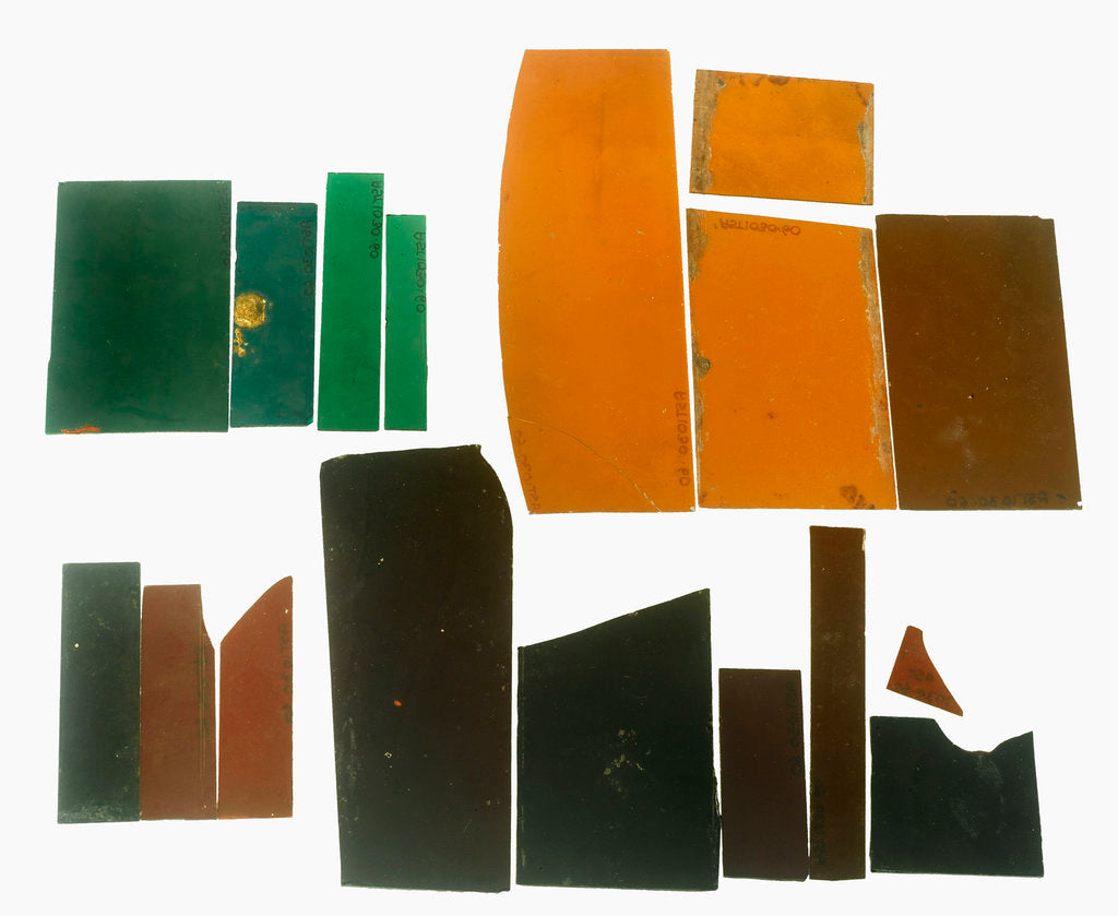 Detail of Eighteen pieces of coloured glass (five amber, three crimson, four dark green, six purple) in a bag by unknown