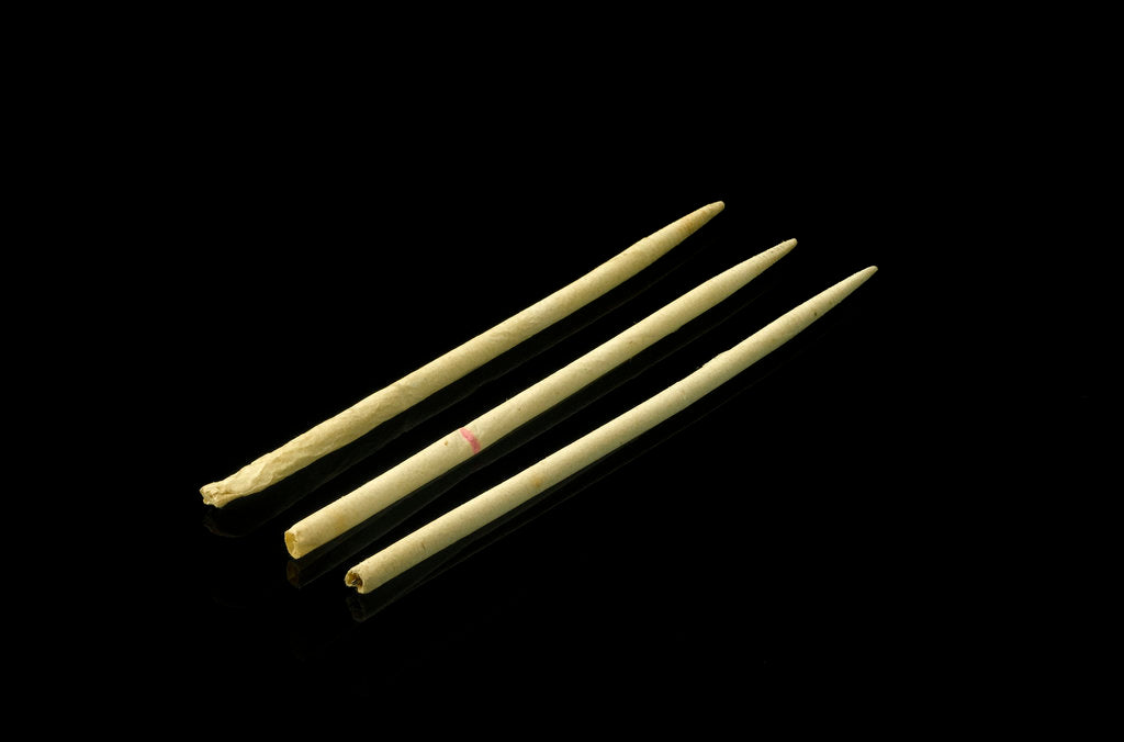 Detail of Three paper 'cocktail sticks', one still has a needle in it by unknown