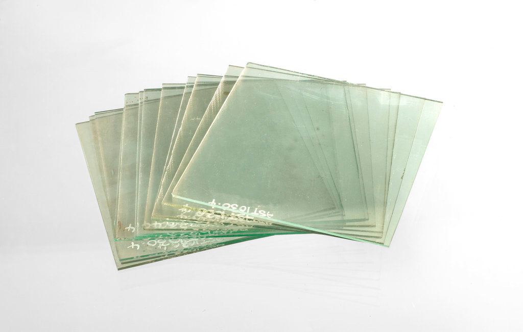 Detail of Thirteen clean cut glass squares in a box by unknown