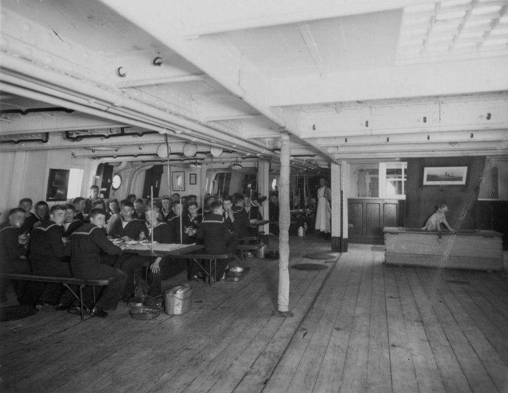 Detail of HMS 'Warspite' (1893) the boys' messdeck during meal time by unknown