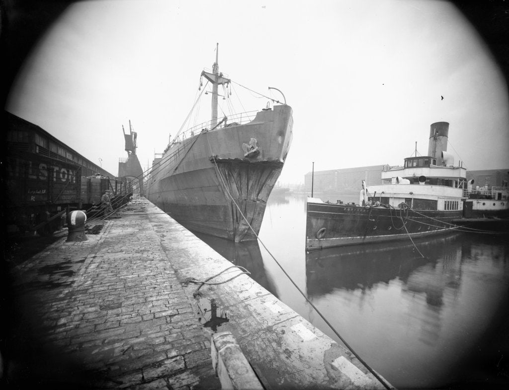 Detail of The 'Dotterel' (Br, 1936) alongside berth at Southampton with a damaged bow, slightly distant. The paddle steamer 'Portsdown' (1928) is berthed close by by unknown