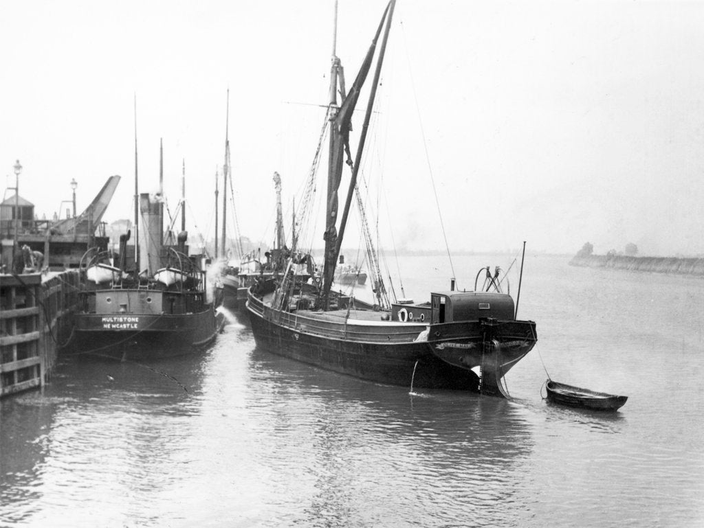 Detail of The 'Olive May' (1920), a port quarter view of the barge motoring to quayside with her tender in tow (sails furled) by Anonymous