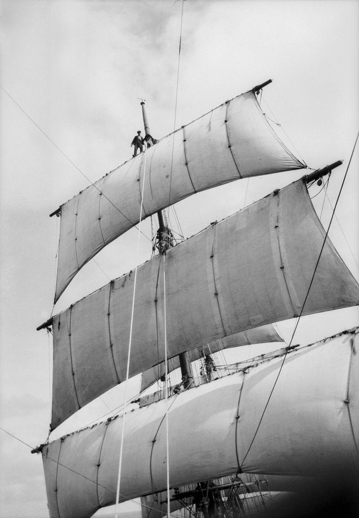 Detail of Standing on the royal yard, the sailor goes about his work aloft as if he were walking along a street by Alan Villiers