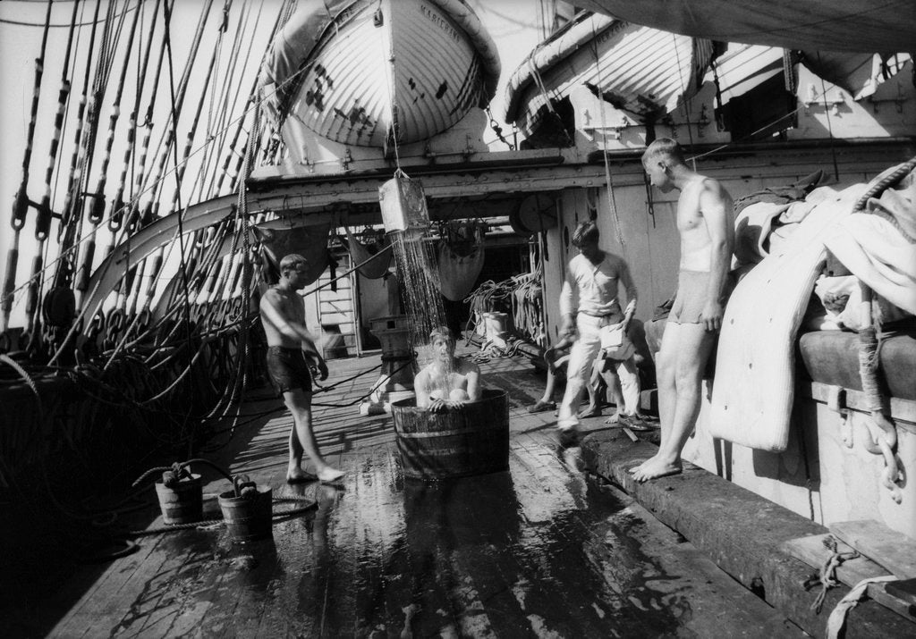 Detail of In the Doldrums after heavy rains, bathing on the well-deck by Alan Villiers