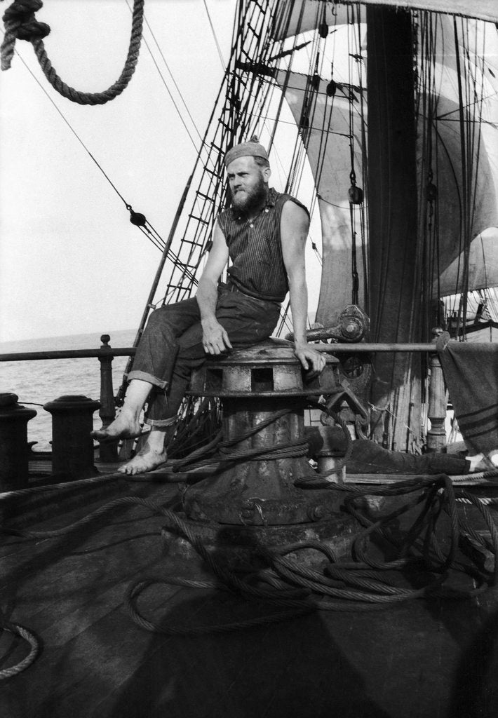 Detail of One of the crew on the forecastle head capstan by Alan Villiers