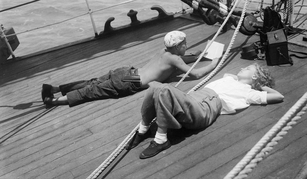 Detail of Elizabeth Jacobsen and Moses relaxing on the forecastle head by Alan Villiers