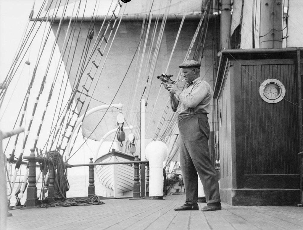 Detail of Captain Ruben de Cloux examining the reading on his sextant by Alan Villiers