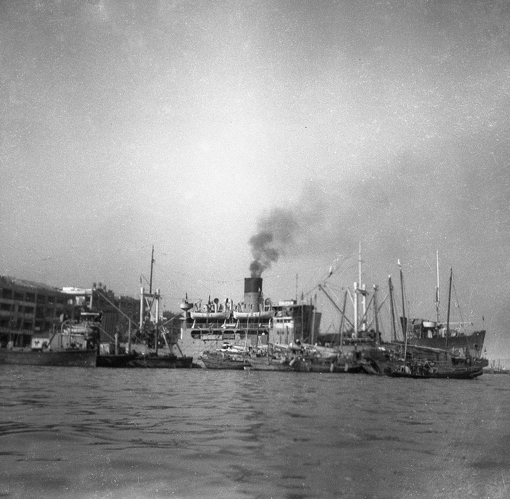 Detail of 'Wing Sang' (Br, 1938), at anchor, surrounded by small craft by unknown