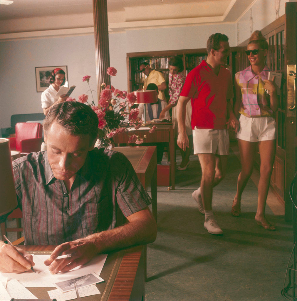 Detail of Passengers on board an unspecified cruiser liner pass the time by writing and walking the ship by Marine Photo Service