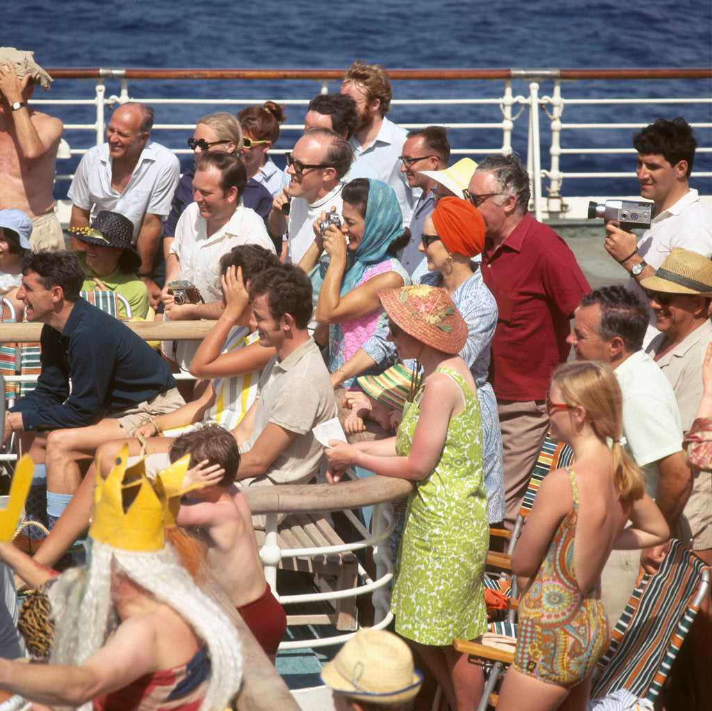Detail of Interested passengers, young and old, enjoy on-deck entertainment aboard an unspecified cruise liner by Marine Photo Service