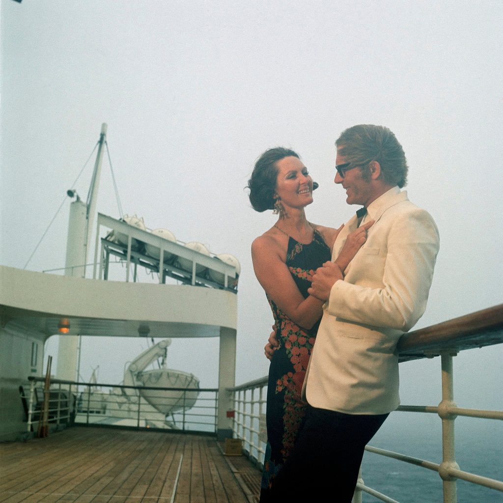 Detail of A misty evening offers amorous opportunities on deck for a romantic, smartly dressed, couple on a cruise ship by Marine Photo Service