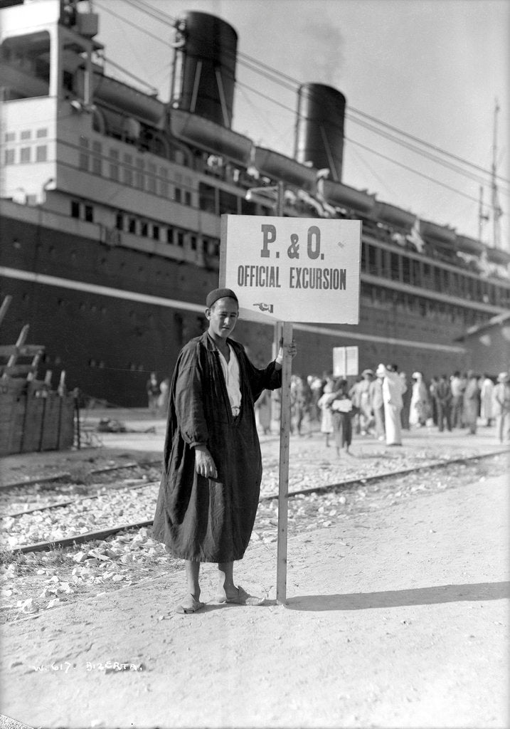 Detail of A Tunisian tour guide posing with his official P & O sign, Bizerte, Tunisia by Marine Photo Service
