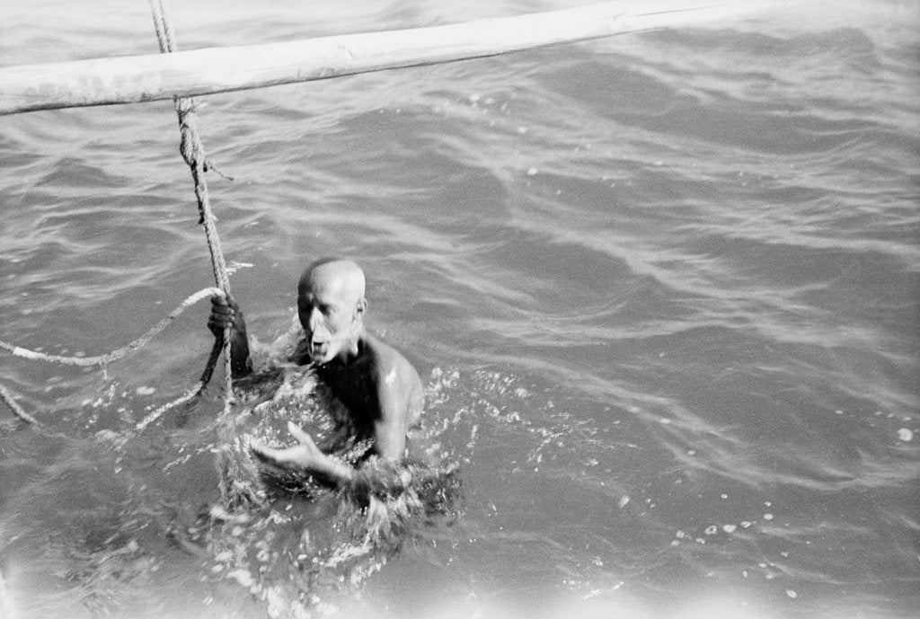 Detail of A Kuwaiti pearl diver draws breath between dives by Alan Villiers