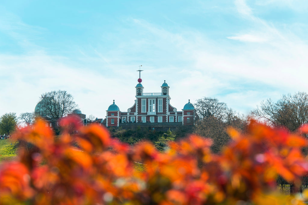 Detail of Royal Greenwich Observatory from Greenwich Park. Autumnal trees in the foreground by National Maritime Museum