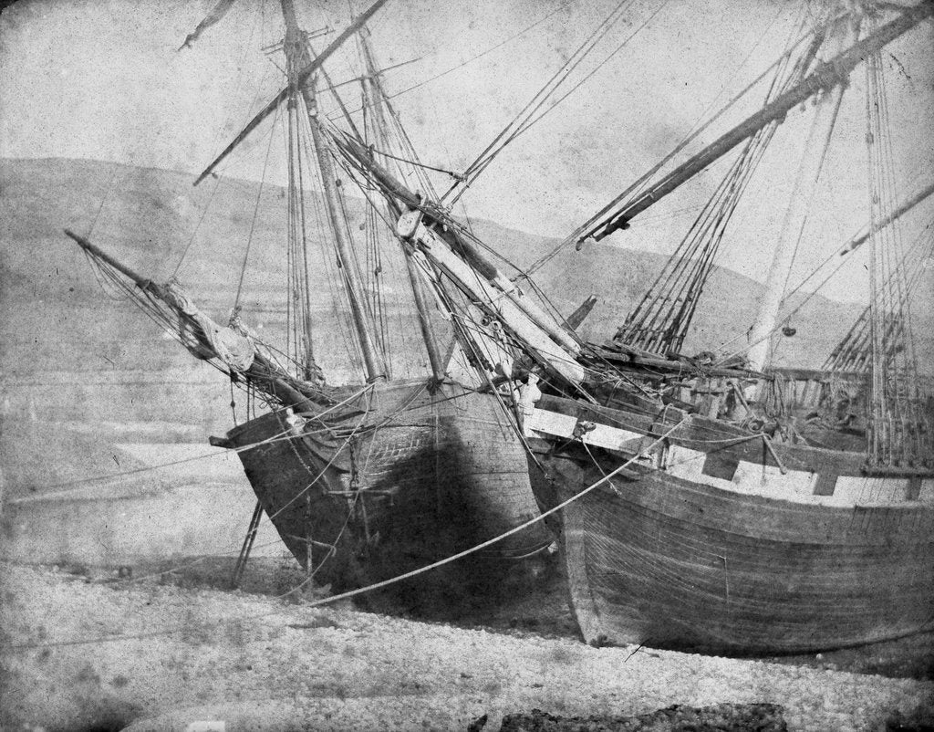 Detail of Bow view of two unidentified vessels at low tide by unknown