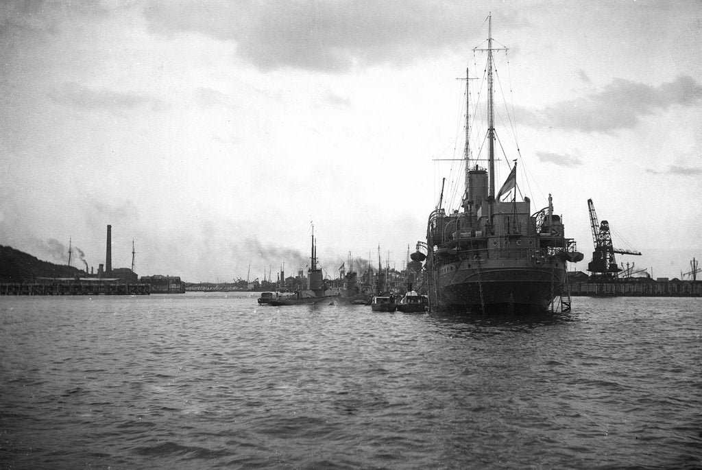 Detail of HMS 'Titania' (1915) submarine depot ship, moored at Portland with 4 submarines alongside by unknown