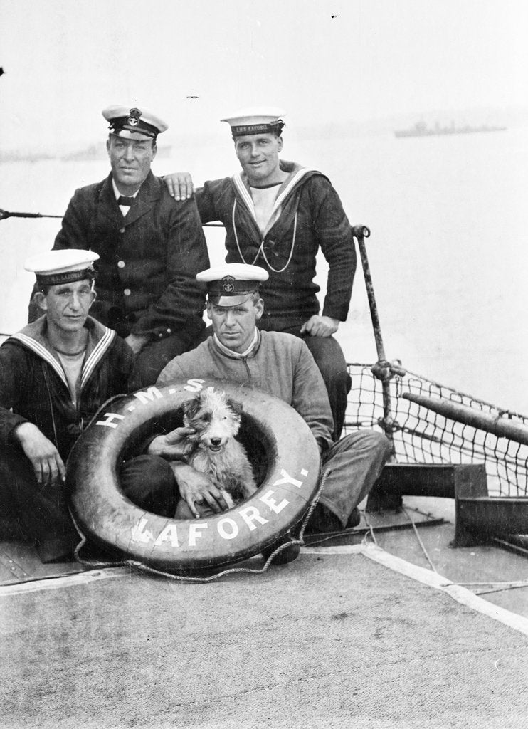 Detail of Photograph of four petty officers on board 'Laforey' (1913) at Harwich in 1915-1916 with the ship's dog mascot by unknown