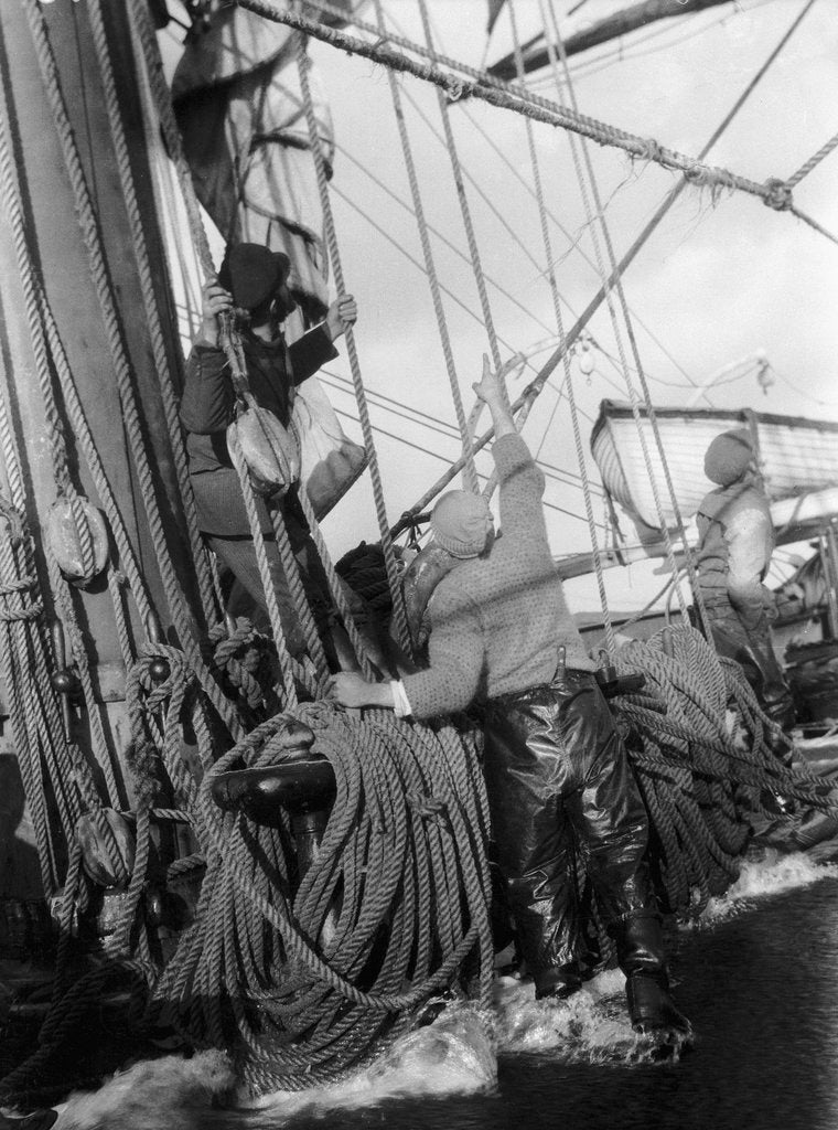 Detail of Horrified sailors watch a shipmate above as some gear parts high aloft by Alan Villiers