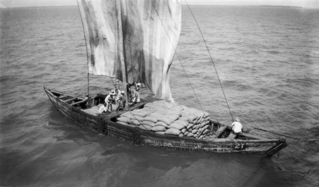 Detail of Indigenous boat at sea, laden with sacks by unknown