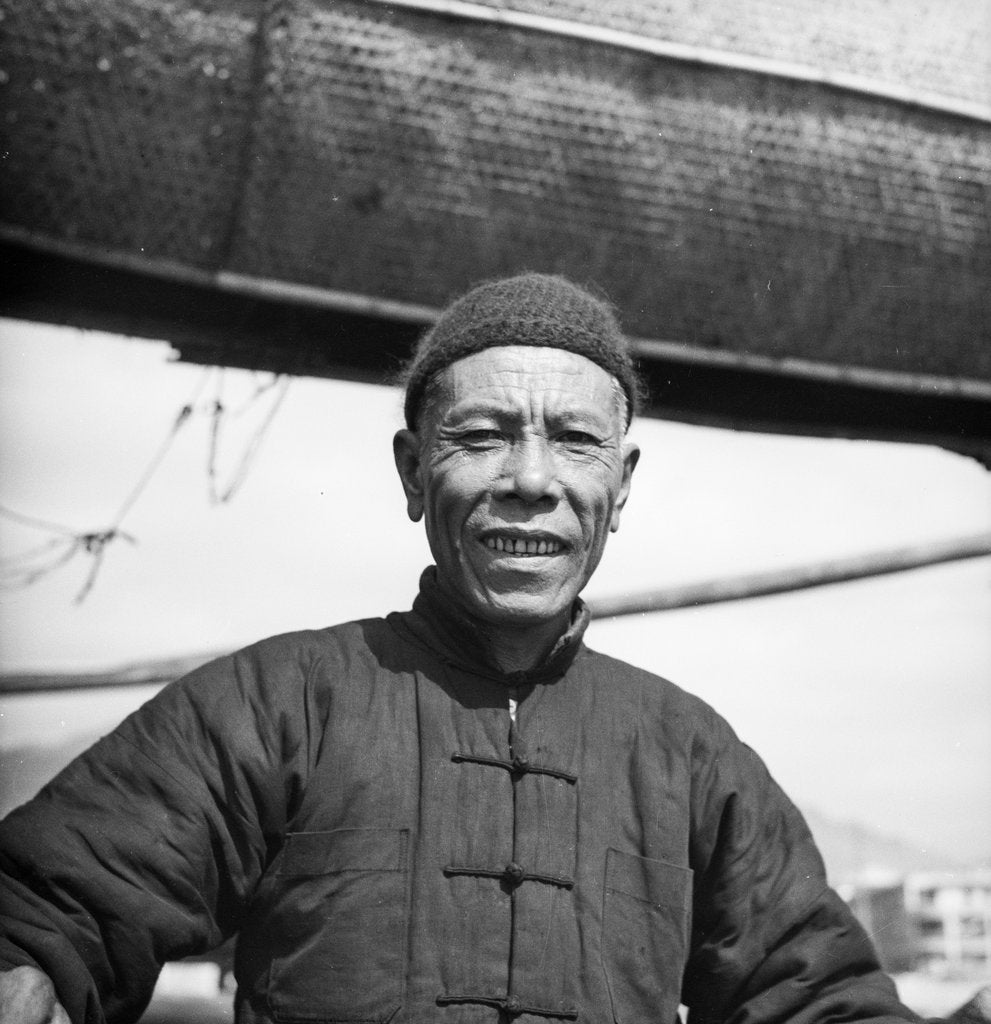Detail of A portrait of one of the crew of a Canton salt junk on board his vessel at Sham Shui Po, Hong Kong by David Watkin Waters