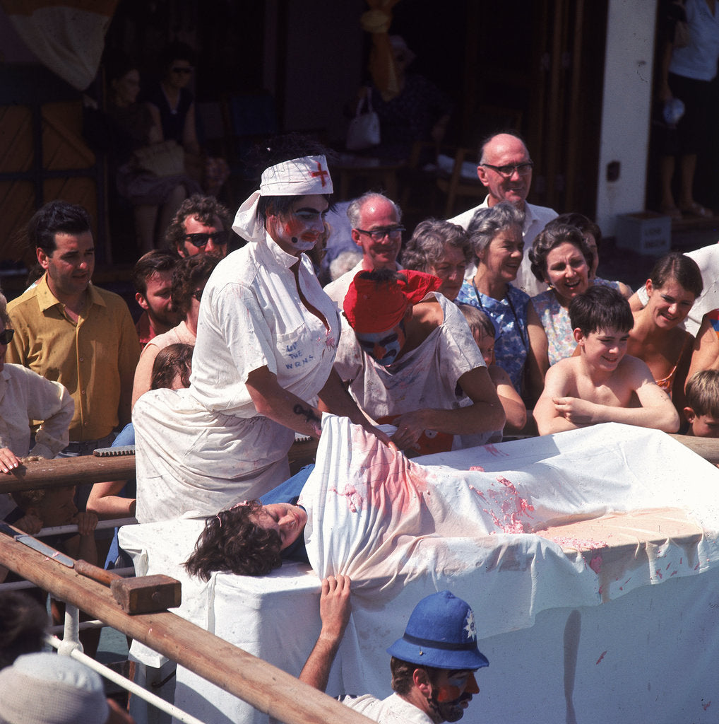 Detail of Macabre comic entertainment aboard an unspecified cruise ship - perhaps a variant of the Crossing the Line (the Equator) ceremony? by Marine Photo Service
