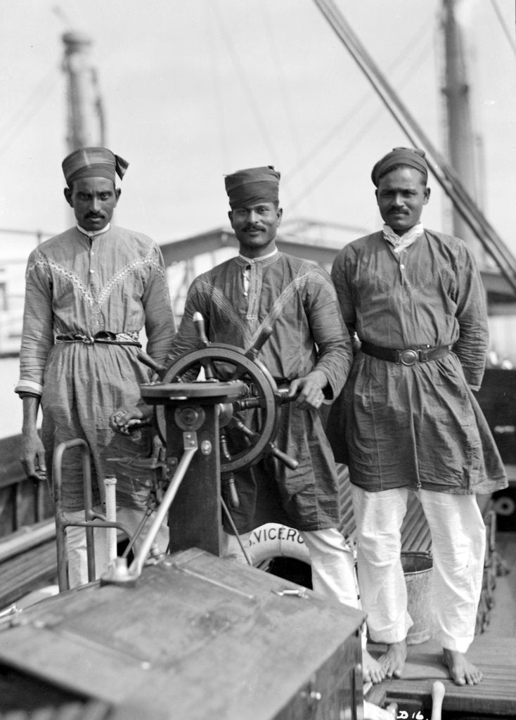 Detail of Three Lascars of the 'Viceroy of India' (1929), standing behind the wheel of one of the ship's tenders by Marine Photo Service