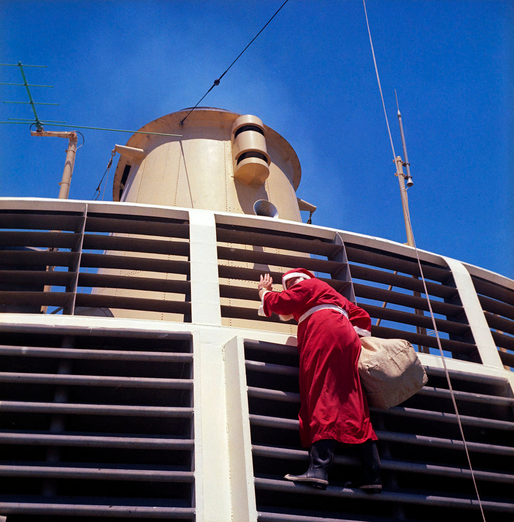 Detail of Father Christmas, or Santa Claus, climbing the grill in front of the forward funnel above the bridge on 'Oriana' (1960) by Marine Photo Service