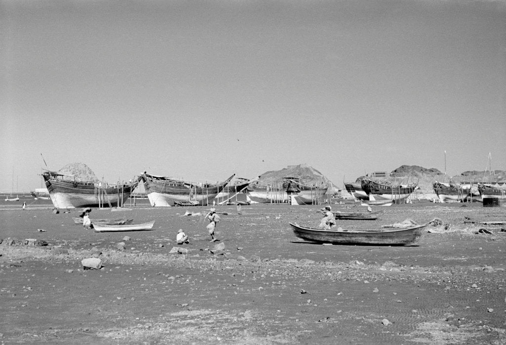 Detail of Booms and other dhows propped at low tide, Ma'alla beach by Alan Villiers